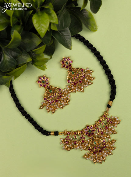 Black thread necklace with kemp stones and pearl & golden beads hanging