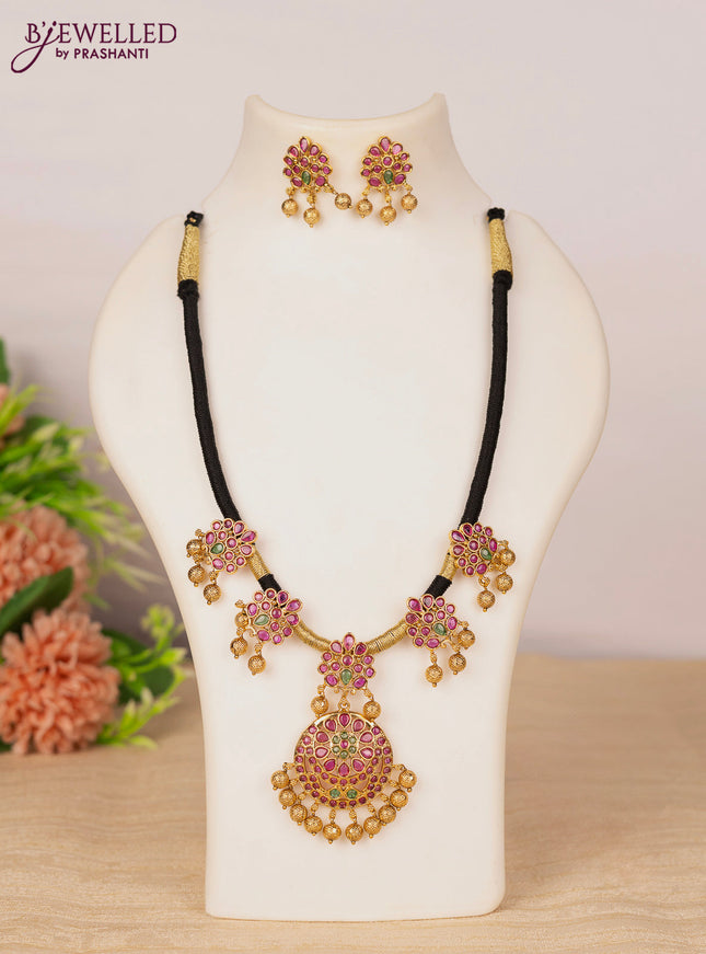 Black thread necklace with kemp stones and golden beads hangings
