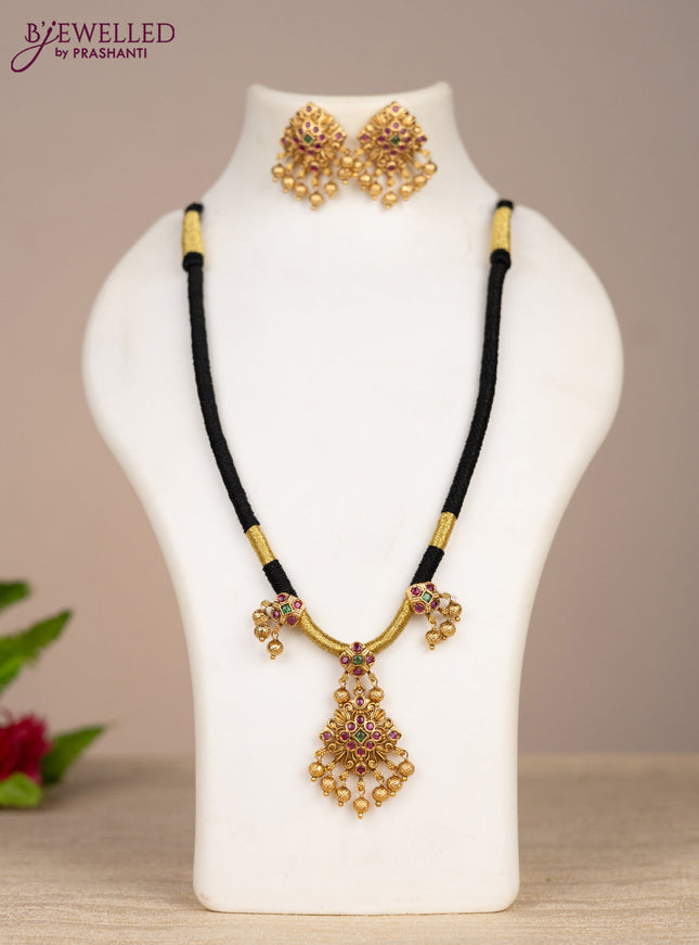 Black thread necklace with kemp stones and golden beads hangings