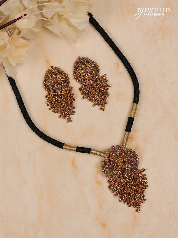 Black thread floral design with kemp stones and golden beads hanging