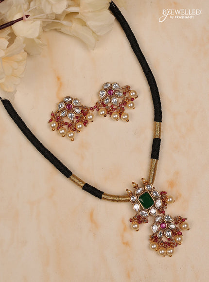 Black thread necklace iwth white kundan stones ,red & green stones and pearl hanging