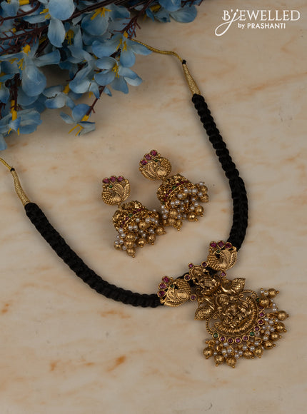 Black thread necklace with lakshmi pendant in multicolor kemp stones and golden ball hanging