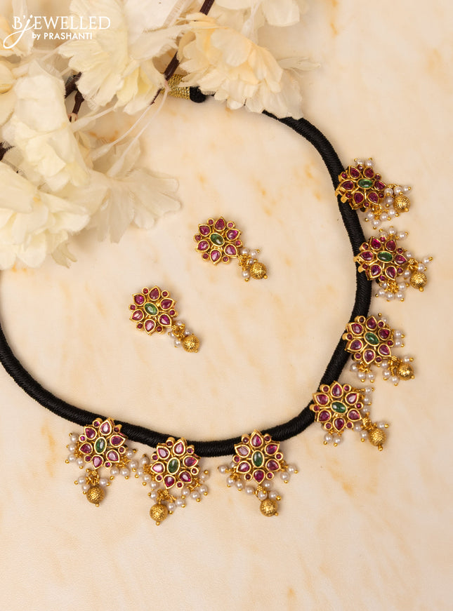 Black thread necklace with kemp stones in pearl and golden beads hangings