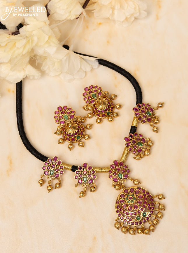 Black thread necklace with kemp stones and golden beads hangings