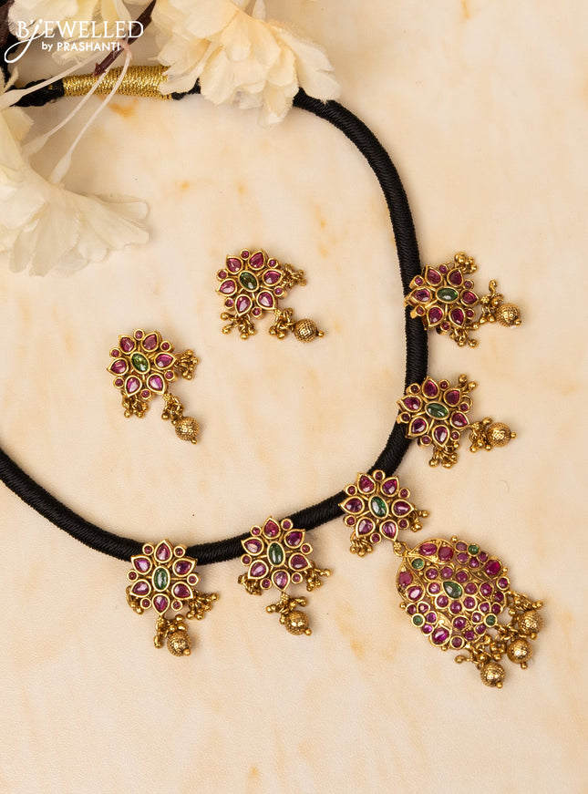 Black thread necklace with kemp stones and golden beads hangings