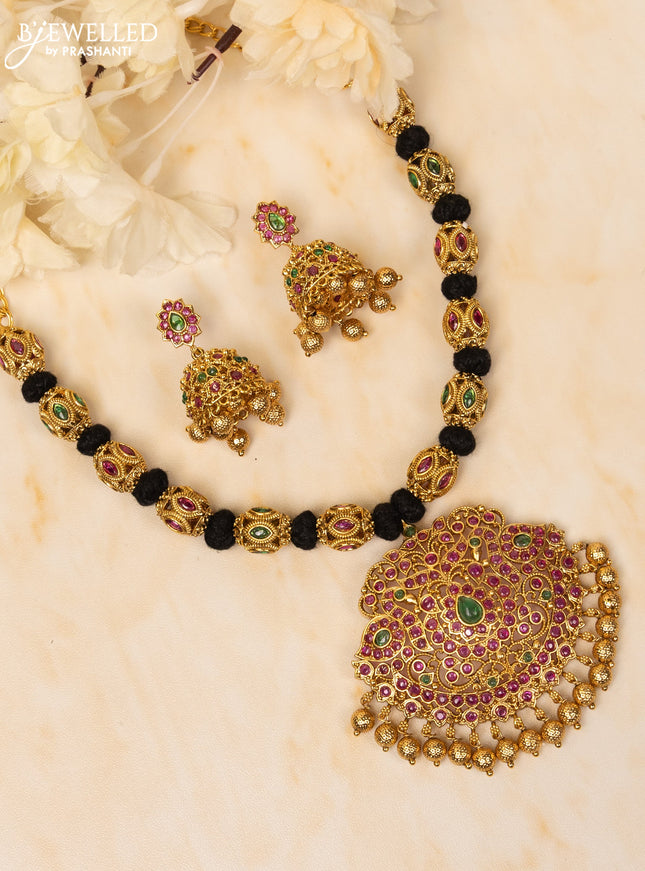 Black thread necklace with kemp stones and golden beads hangings