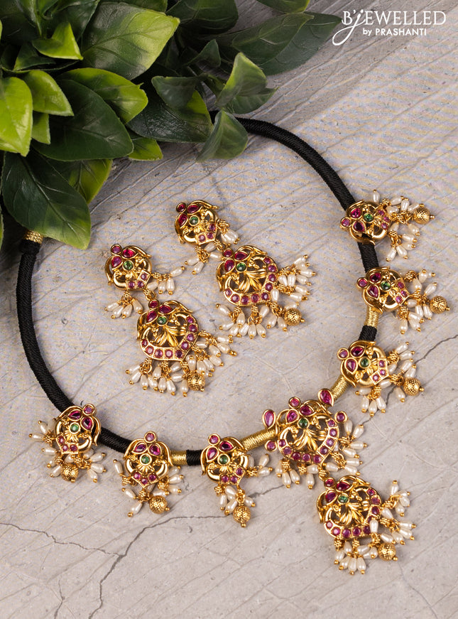 Black thread necklace with kemp stones and pearl & golden beads hanging