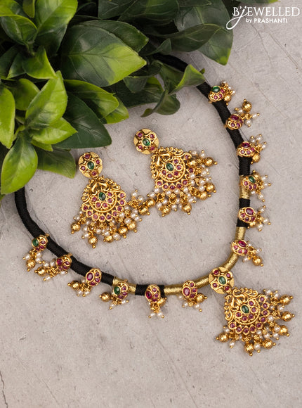Black thread necklace with kemp stones and pearl & golden beads hanging