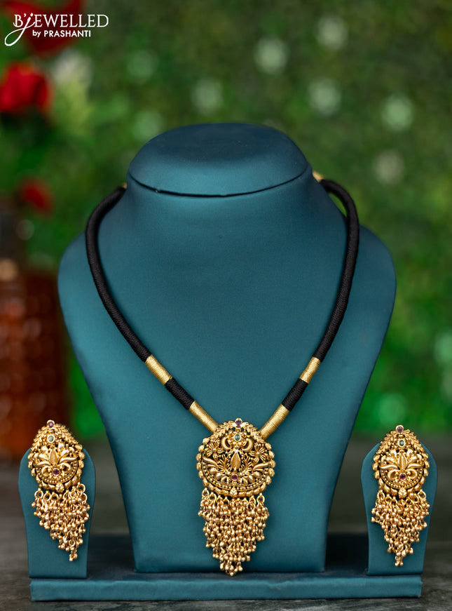 Black thread necklace with kemp stones and golden beads hanging