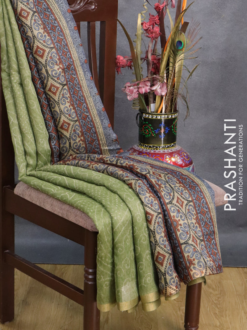 Semi linen saree pastel green  with allover bandhani prints and ajrakh prints pallu