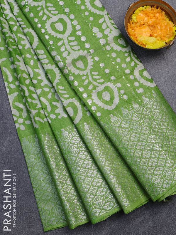 Semi tussar saree light green with allover batik prints & sequin work pallu and long temple design silver zari woven border