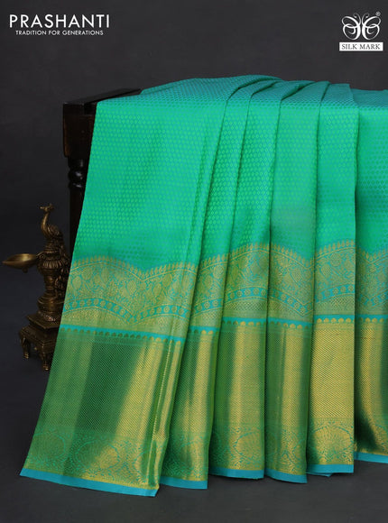 Pure kanchipuram silk saree dual shade of teal green and teal blue with allover self emboss and long zari woven border