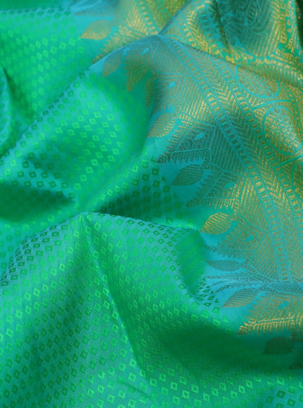 Pure kanchipuram silk saree dual shade of teal green and teal blue with allover self emboss and long zari woven border