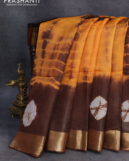 Banana silk saree orange and brown with tie and dye batik butta prints and zari woven border