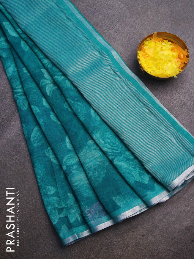 Pure linen saree teal blue with allover prints and silver zari woven piping border