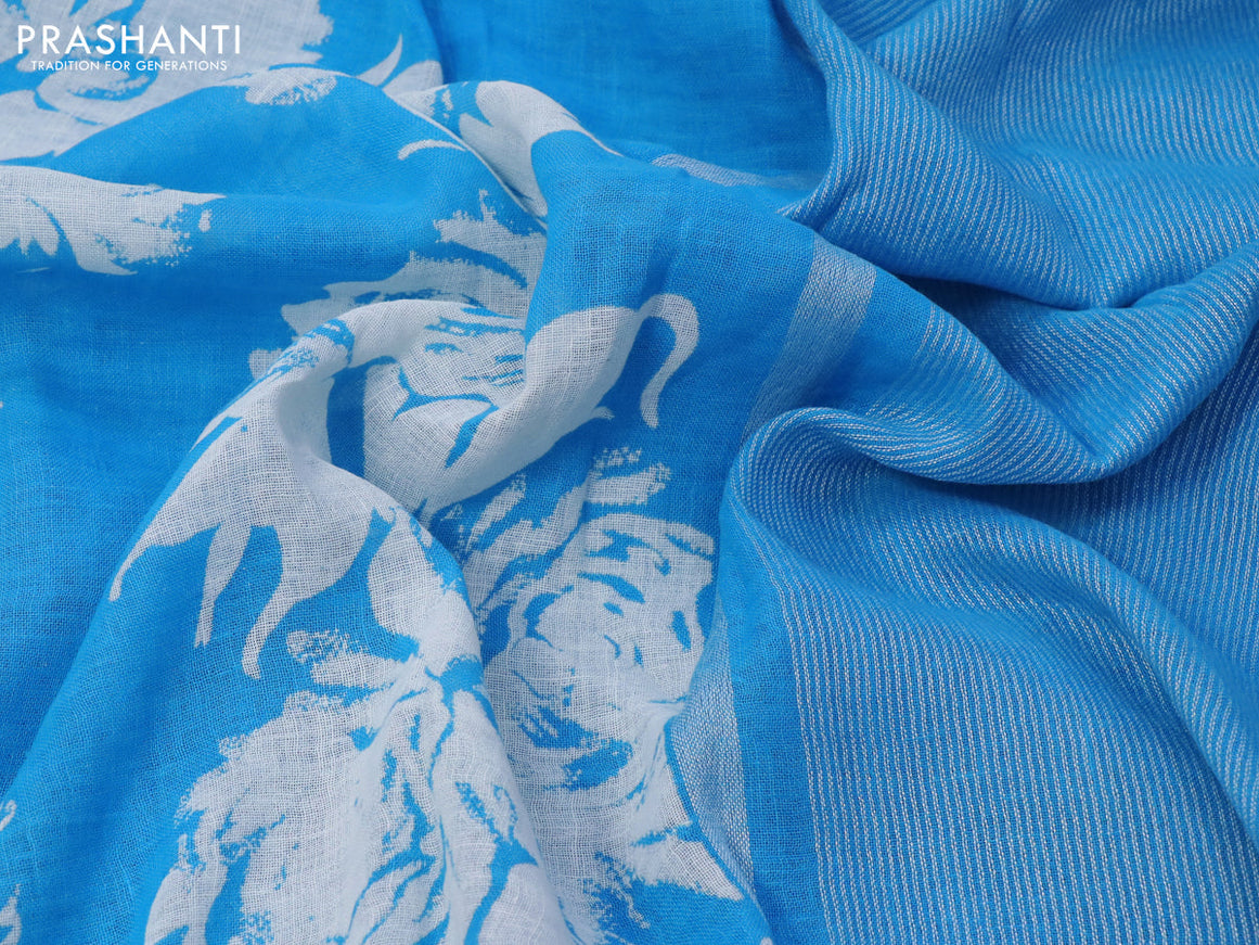 Pure linen saree light blue with allover floral prints and silver zari woven piping border