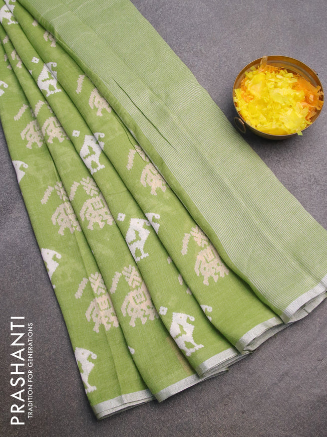 Pure linen saree light green with patola prints and silver zari woven piping border