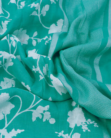 Pure linen saree teal blue with allover floral prints and silver zari woven piping border