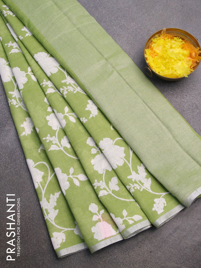 Pure linen saree light green with allover floral prints and silver zari woven piping border