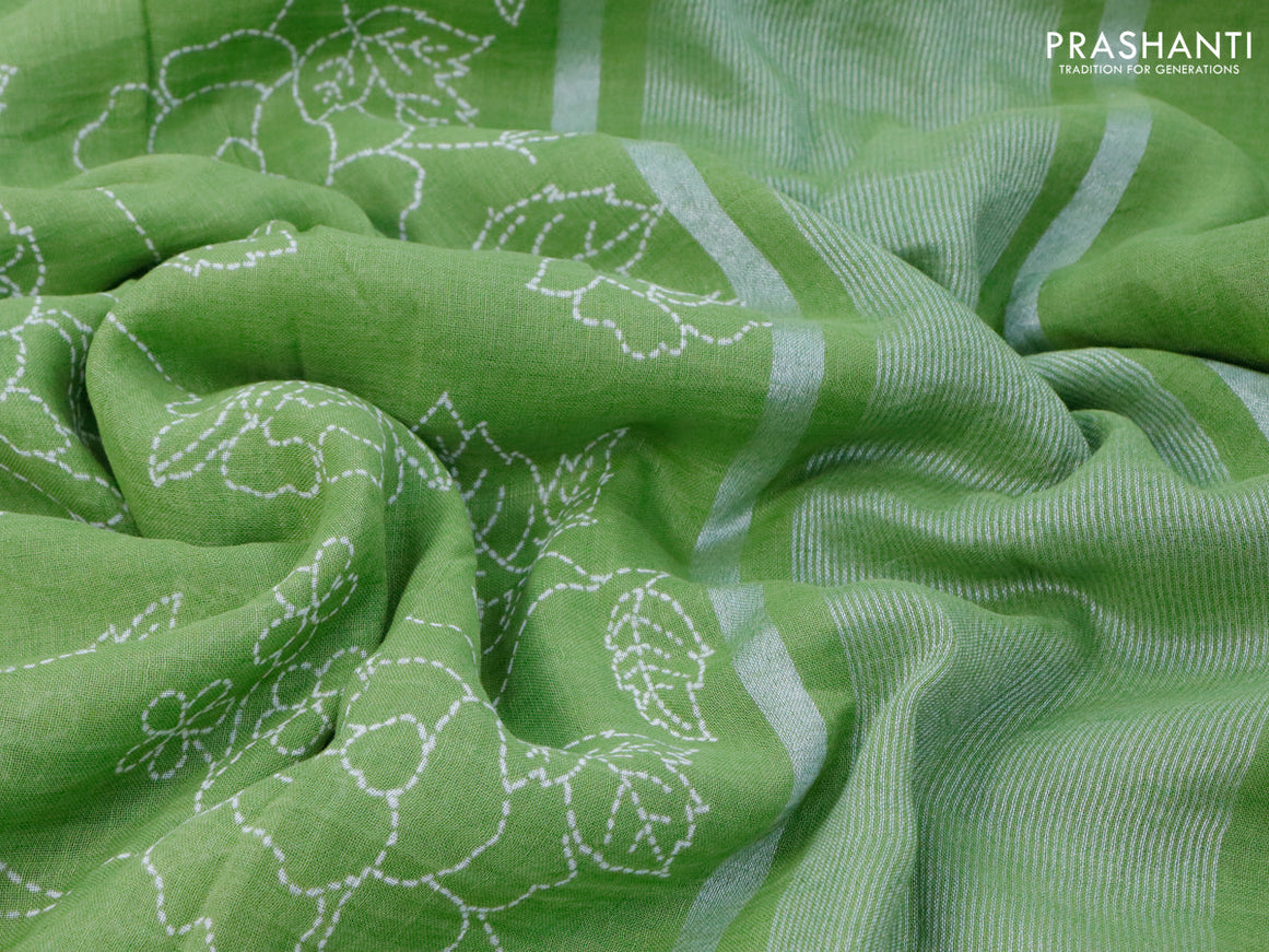 Pure linen saree light green with allover prints and silver zari woven piping border