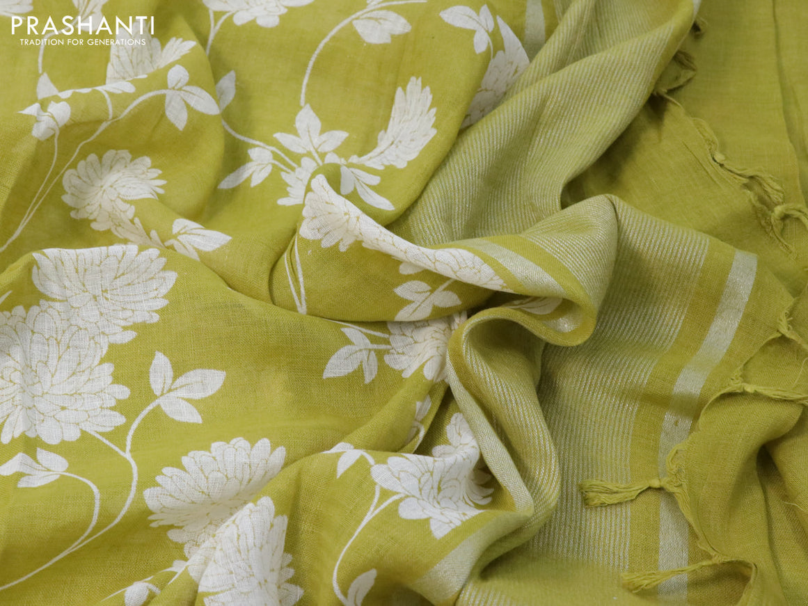 Pure linen saree lime green with allover floral prints and silver zari woven piping border