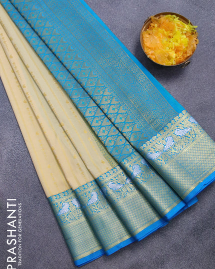 Semi kanjivaram silk saree cream and cs blue with allover zari weaves and zari woven korvai border