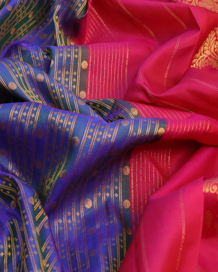 Pure gadwal silk saree dual shade of bluish green and pink with allover zari weaves and zari woven floral border