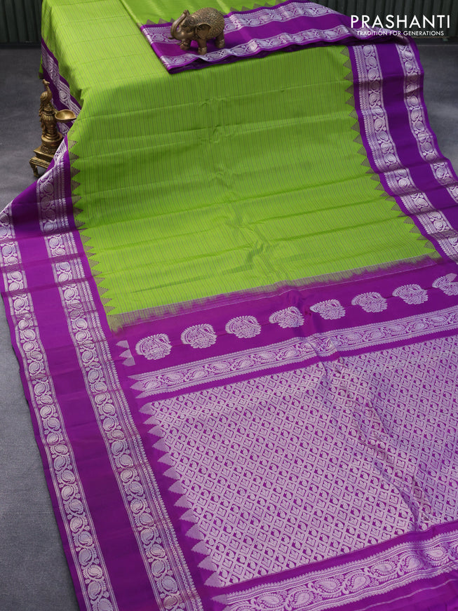 Pure gadwal silk saree light green and deep purple with allover stripes pattern and temple design rettapet silver zari woven border