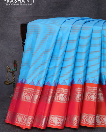 Pure gadwal silk saree light blue and dual shade of pinkish orange with allover stripes pattern and temple design rettapet silver zari woven border