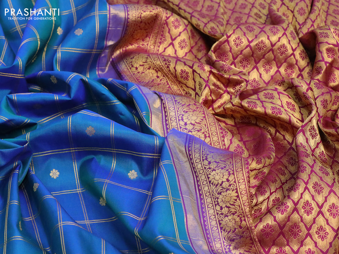 Pure gadwal silk saree dual shade of bluish green and deep purple with allover zari checked pattern & buttas and floral zari woven border