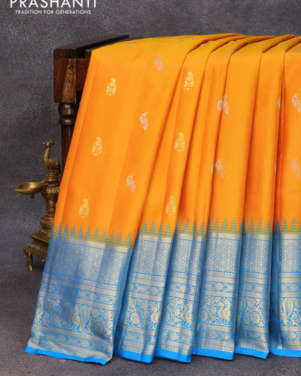 Pure gadwal silk saree mango yellow and cs blue with silver & gold zari woven peacock buttas and temple design zari woven border
