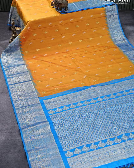 Pure gadwal silk saree mango yellow and cs blue with silver & gold zari woven peacock buttas and temple design zari woven border