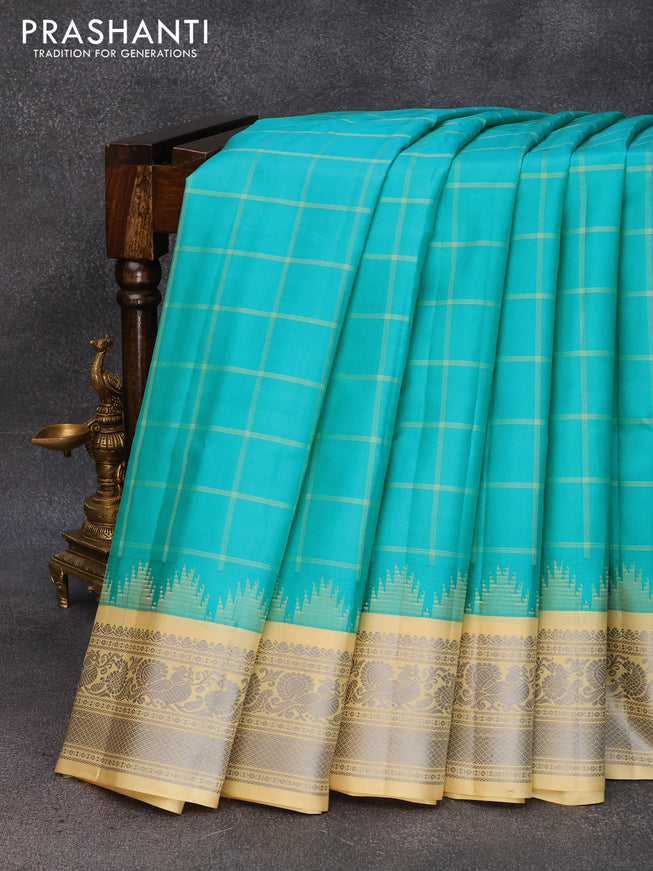 Pure gadwal silk saree teal blue and sandal with allover checked pattern and temple design thread woven border