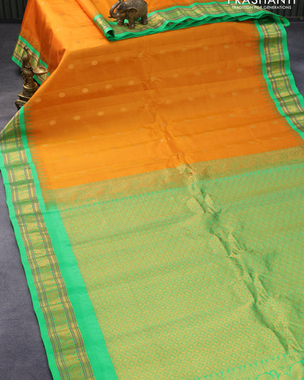 Pure gadwal silk saree orange and light green with zari woven floral buttas and temple design annam zari woven border