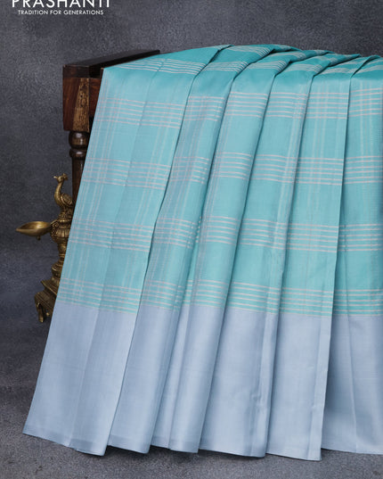 Pure soft silk saree teal blue0 and pastel grey with allover checked pattern and simple border