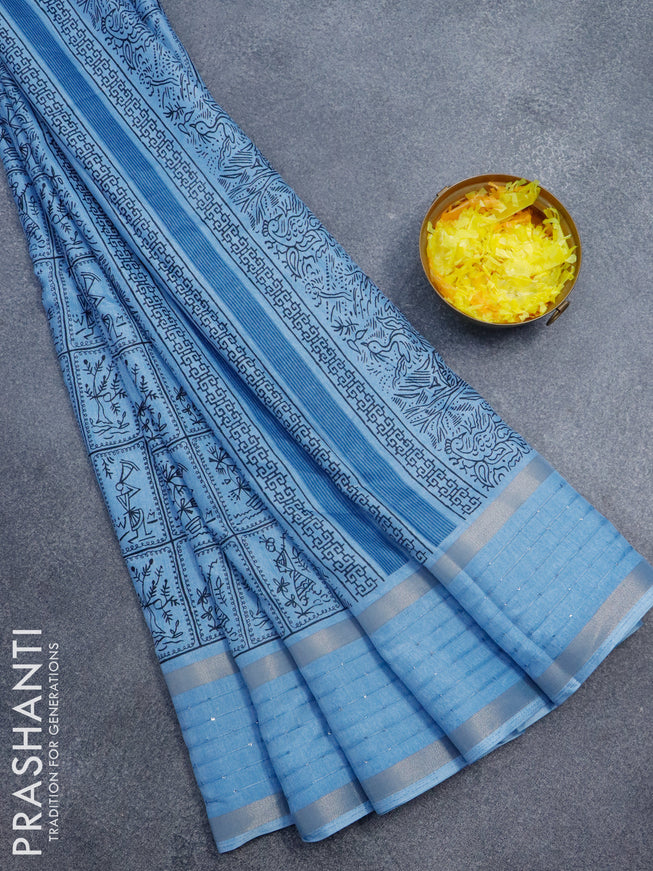Semi dola saree blue shade with allover warli prints and zari woven sequin work border