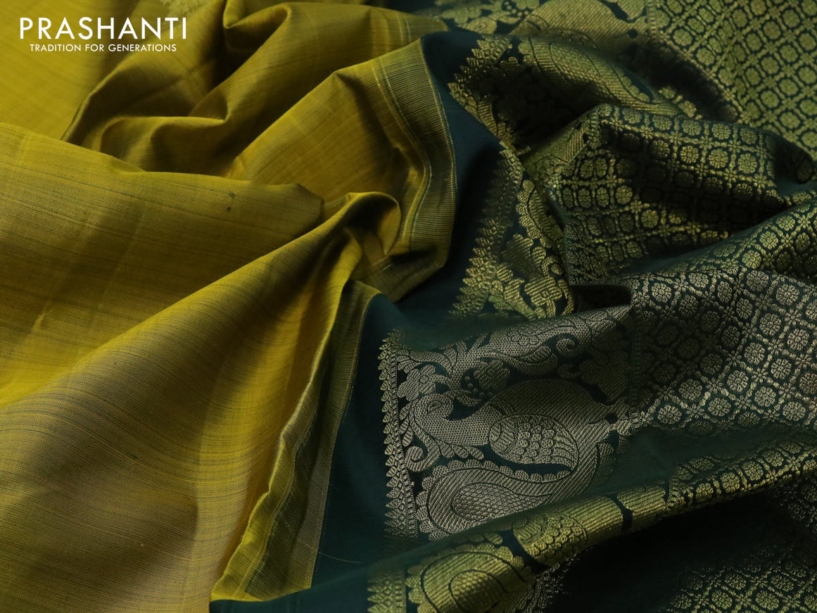 Pure kanjivaram silk saree dual shade of mustard and dark green with peacock zari woven buttas and long rich zari woven border