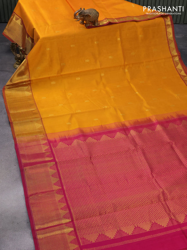 Silk cotton saree mustard yellow and magenta pink with zari woven paisley buttas and temple zari woven border