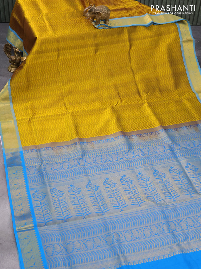 Silk cotton saree dark mustard and cs blue with allover self emboss jaquard and zari woven border