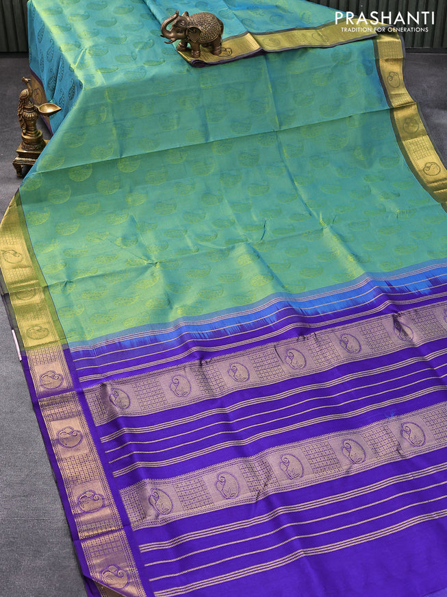 Silk cotton saree dual shade of teal bulish green and blue with allover self emboss jaquard and zari woven border