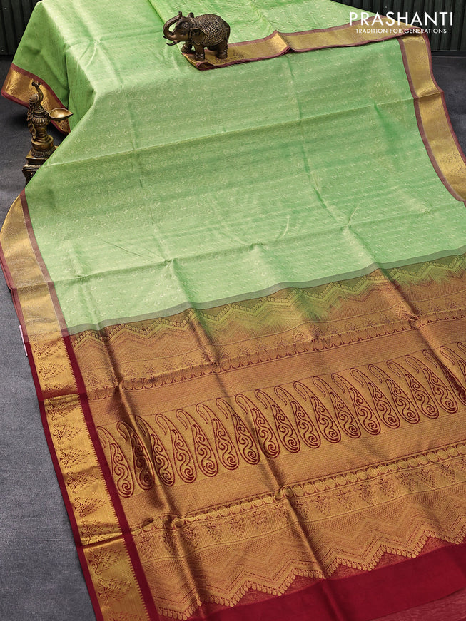 Silk cotton saree light green and maroon with allover self emboss jaquard and temple zari woven border