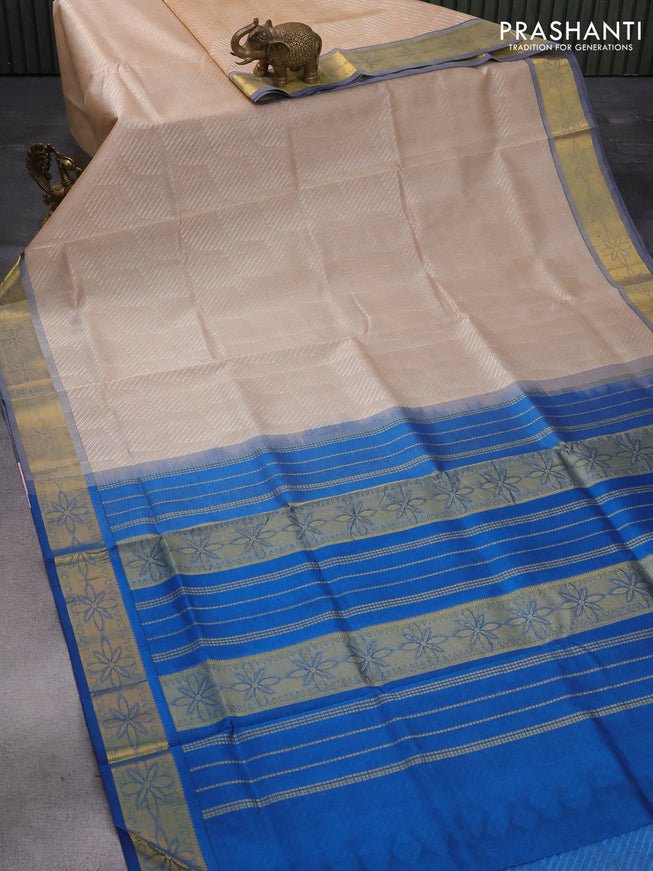 Silk cotton saree beige and peacock blue with allover self emboss jaquard and floral zari woven border