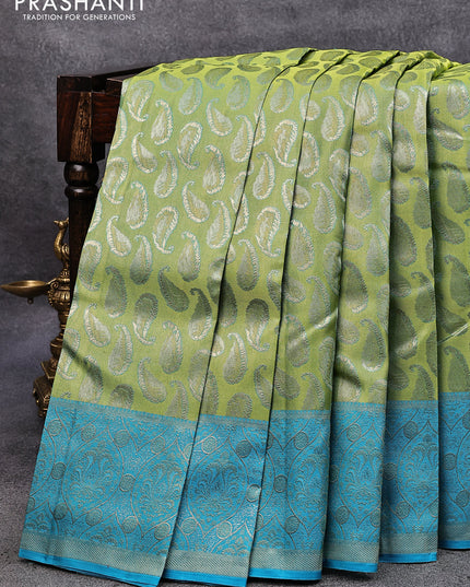 Pure kanjivaram tissue silk saree dual shade of light green and blue with allover zari woven paisley butta weaves and rich zari woven border
