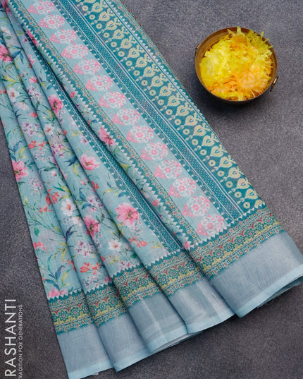 Linen cotton saree teal blue with allover floral prints and silver zari woven border