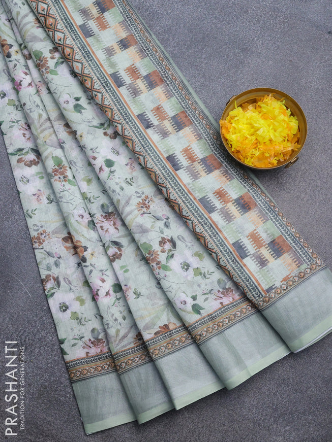 Linen cotton saree pastel green with allover floral prints and silver zari woven border