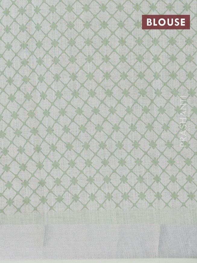 Linen cotton saree green shade with allover floral prints and silver zari woven border