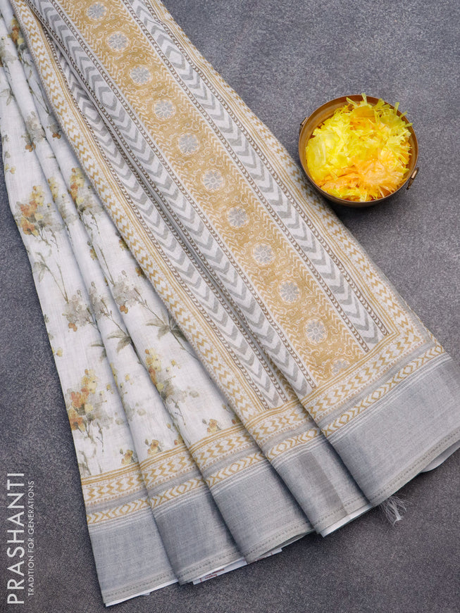 Linen cotton saree off white and grey with allover floral prints and silver zari woven border