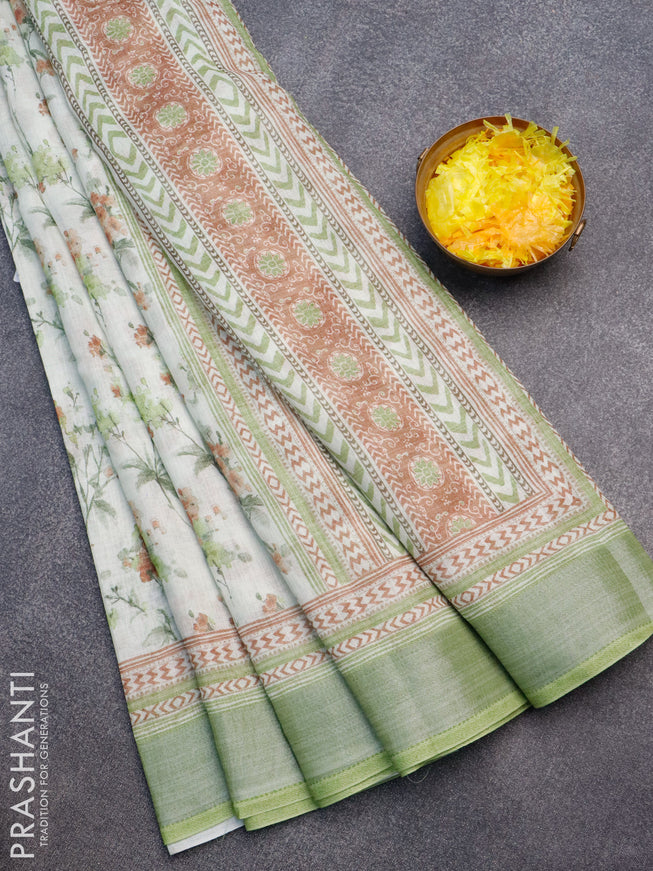 Linen cotton saree mild pista green and light green with allover floral prints and silver zari woven border