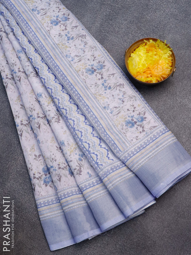 Linen cotton saree off white and pastel blue with allover floral prints and silver zari woven border