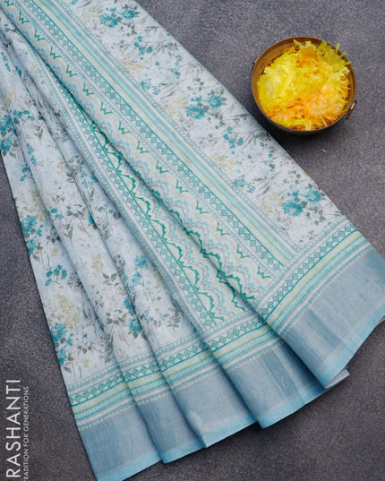 Linen cotton saree pastel teal blue with allover floral prints and silver zari woven border